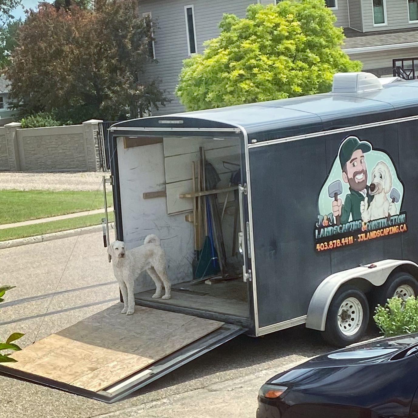 Jack beside the J&J Landscaping and Construction trailer